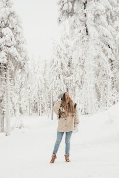 Woman exploring the snow-covered Bavarian forest during winter in Munich, Germany.