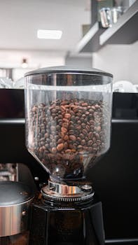 Close-up of coffee beans in a grinder, capturing the rich aroma and texture.