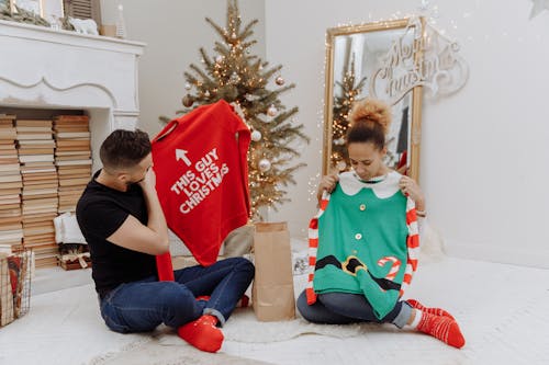 Free A Couple Holding Christmas Sweaters Stock Photo
