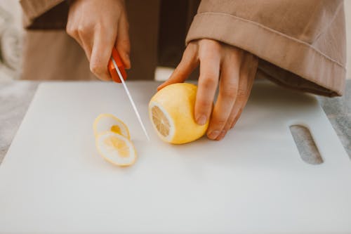 A Person Cutting Lemon 