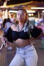 Woman Wearing a Crop Top Posing Beside the Railing