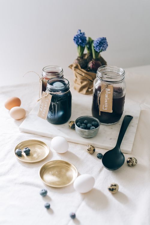 Free Rustic setup of Easter egg dyeing using natural blueberry dye in jars. Stock Photo