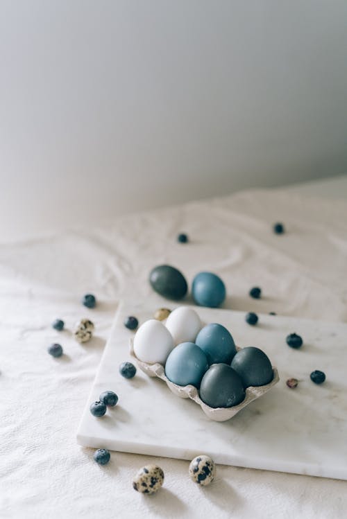 Different Eggs And Blueberries On Table