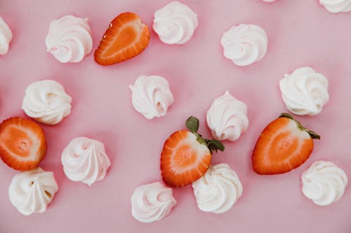 Sliced Strawberries and Cream on Pink Surface