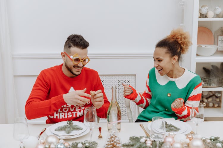 Man And Woman Wearing Christmas Sweaters