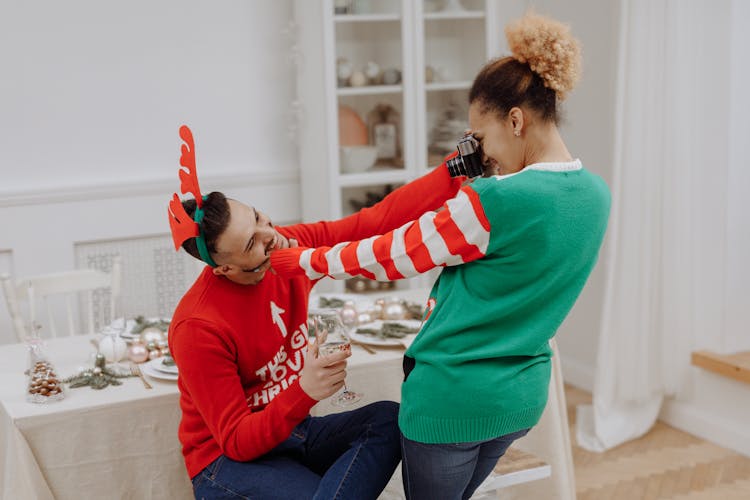 A Couple Wearing Christmas Sweaters