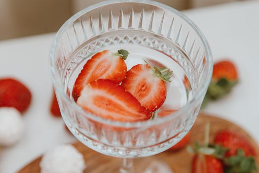 A Clear Glass with Slices of Strawberries in Close up Photography