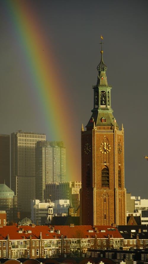 Clock Tower and Rainbow above a City