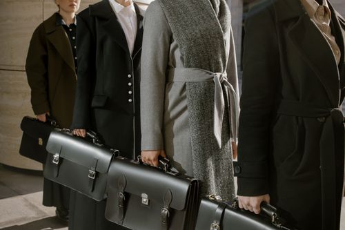 Free A group of professionals in coats holding briefcases, ready for business. Stock Photo