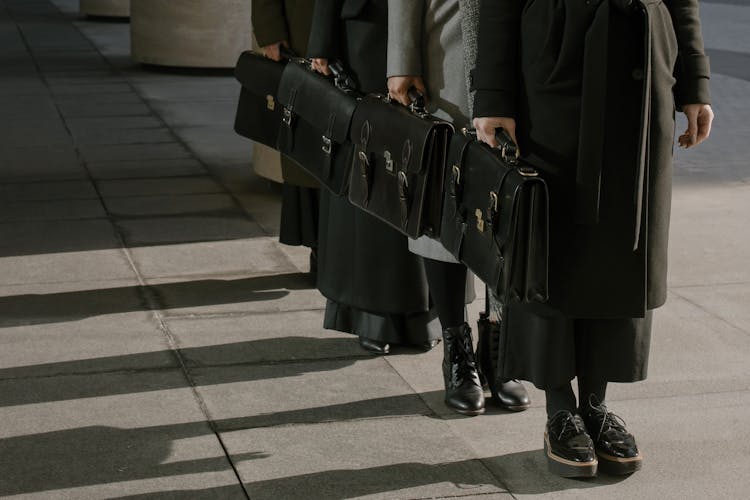 People Holding Briefcases