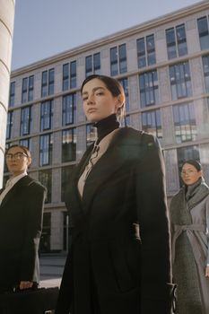 Confident businesswomen in corporate attire outdoors with modern architecture.