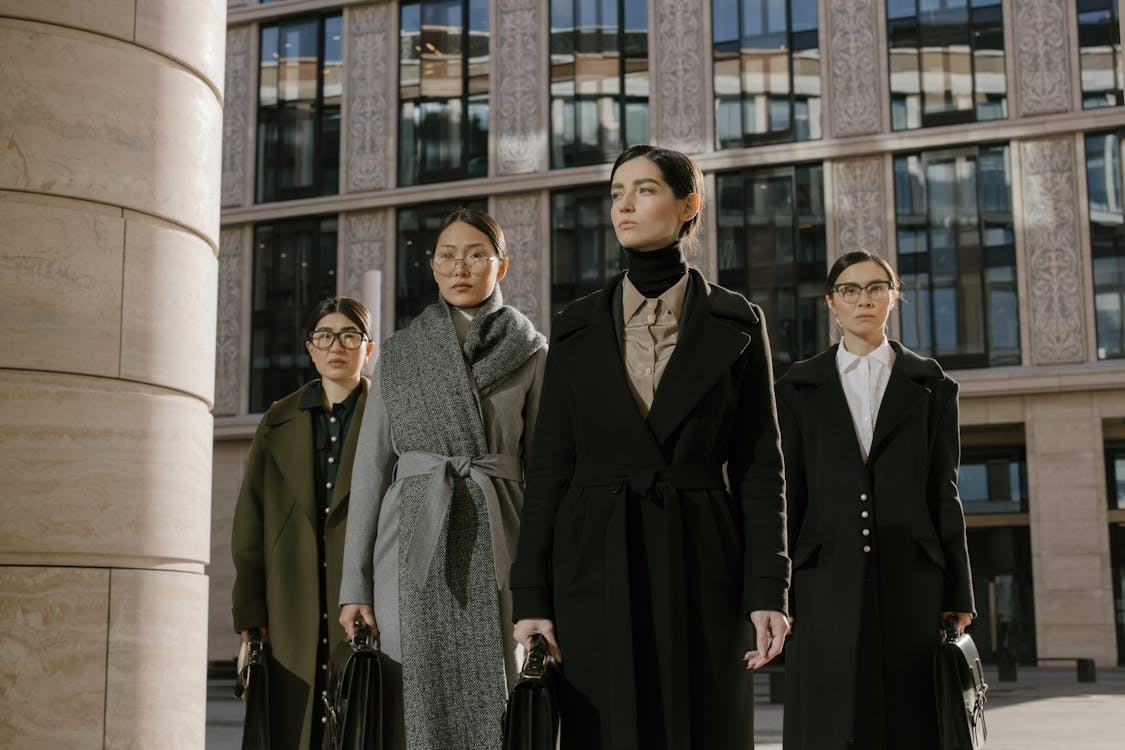 Women with Eyeglasses Standing Behind a Woman in Black Coat · Free ...