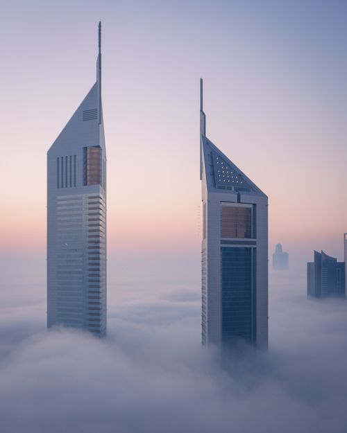 Free Stunning view of Dubai skyscrapers immersed in fog at dawn, showcasing urban elegance. Stock Photo