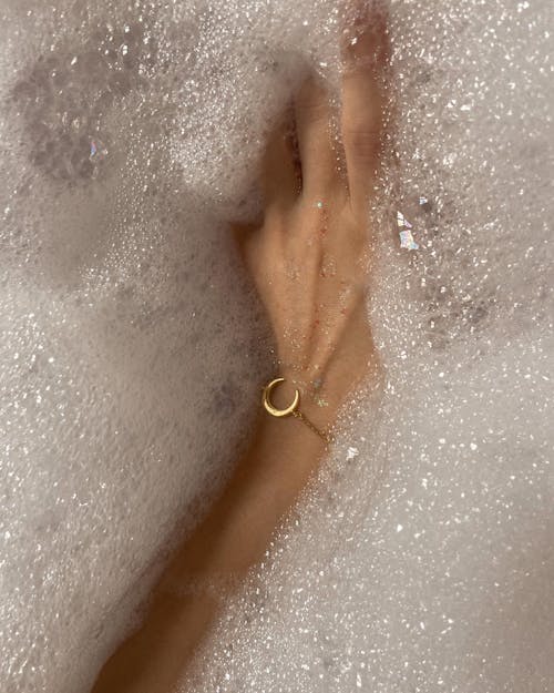 Free Woman with bracelet taking bath with foam Stock Photo