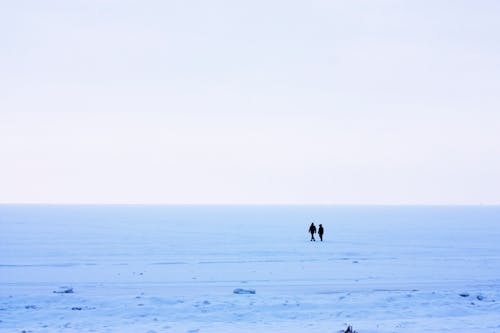 People Walking on Snow Covered Ground