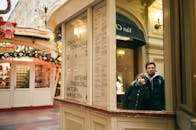 Couple taking picture and reflecting in mirror on street