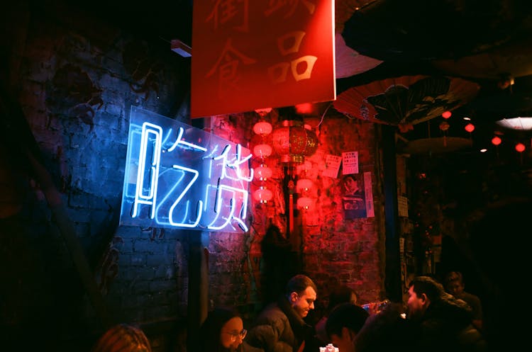 Creative Crowded Pub With Grunge Brick Walls And Neon Lights