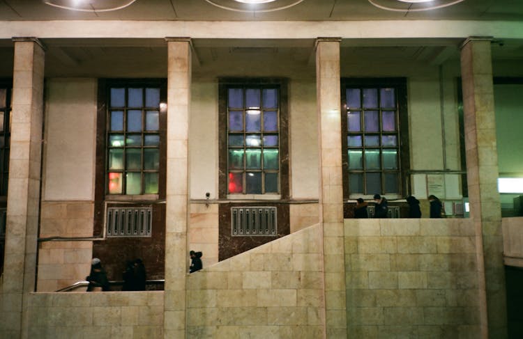 People Walking Downstairs On Grand Building Entrance