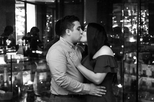Grayscale Photography of a Couple Kissing