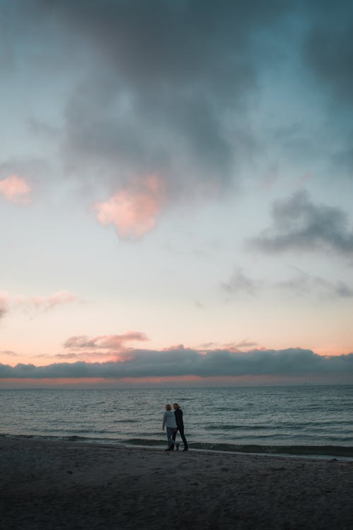 A Couple Walking on the Shore