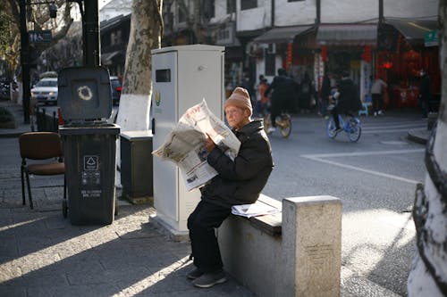 A Man Sitting on the Concrete Bench