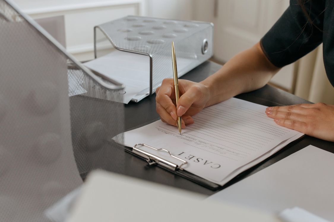A Person Writing on the Paper · Free Stock Photo