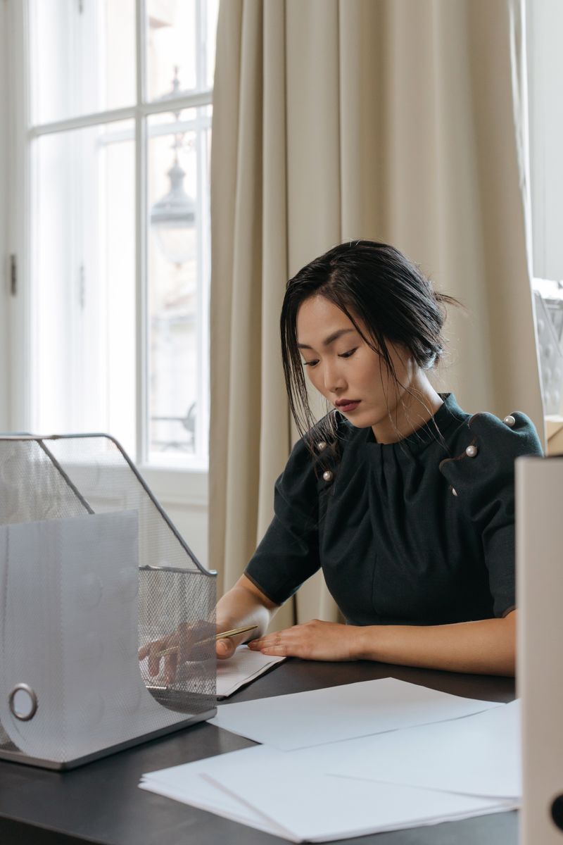 Finance lead reviewing paperwork at a desk — photo by cottonbro studio on Pexels