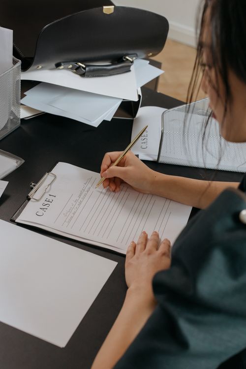 A Person Holding a Pen · Free Stock Photo