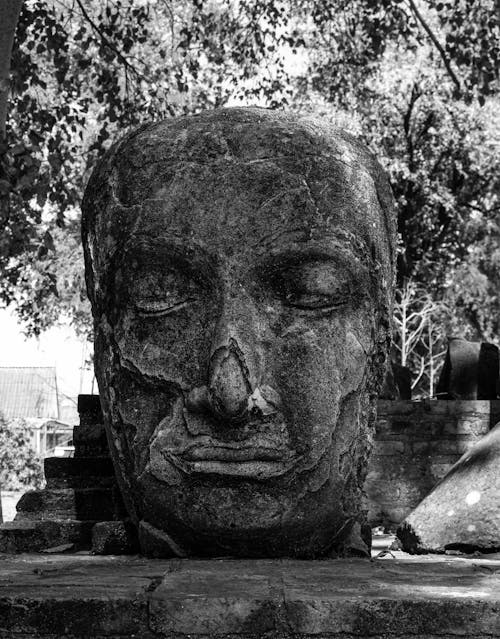 Grayscale Photo of a Stone Head Statue