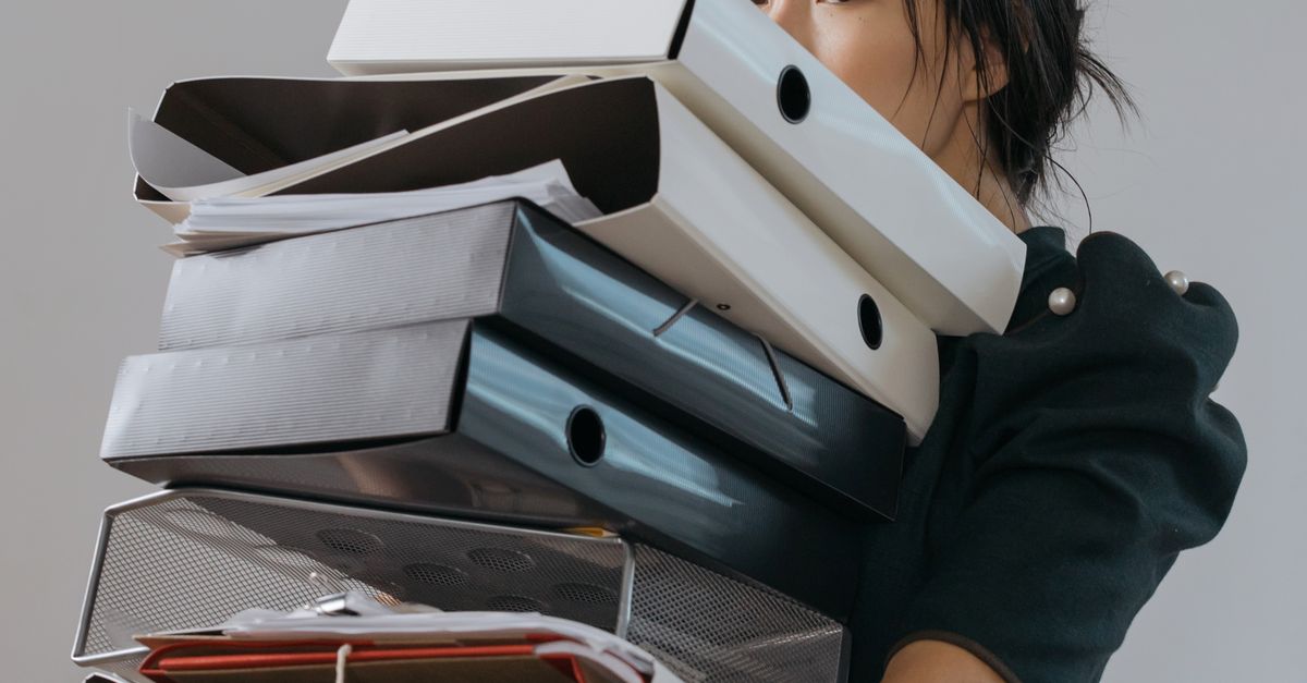 Someone Filing Files Folder A Woman Holding a Pile of File Folders · Free Stock Photo