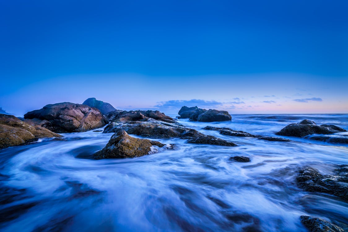 A Scenic Landscape Surrounded by the Ocean Under the Clear Blue Sky