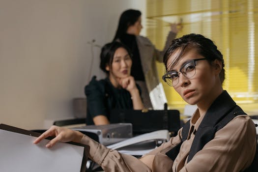 Focused business professionals in a modern office setting discussing reports.