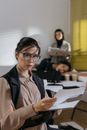 Woman in Black Blazer Holding White Paper