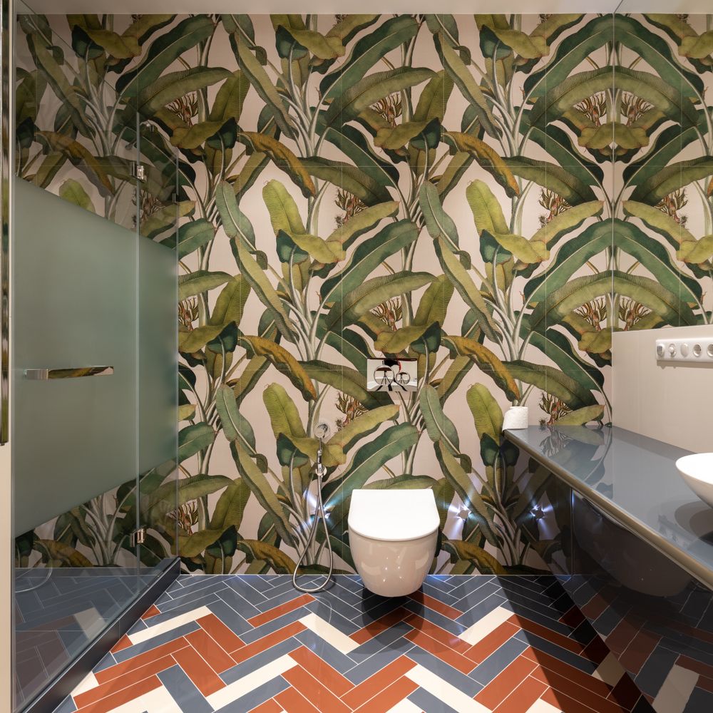 Wallpapering in Arkley — careful masking before painting begins