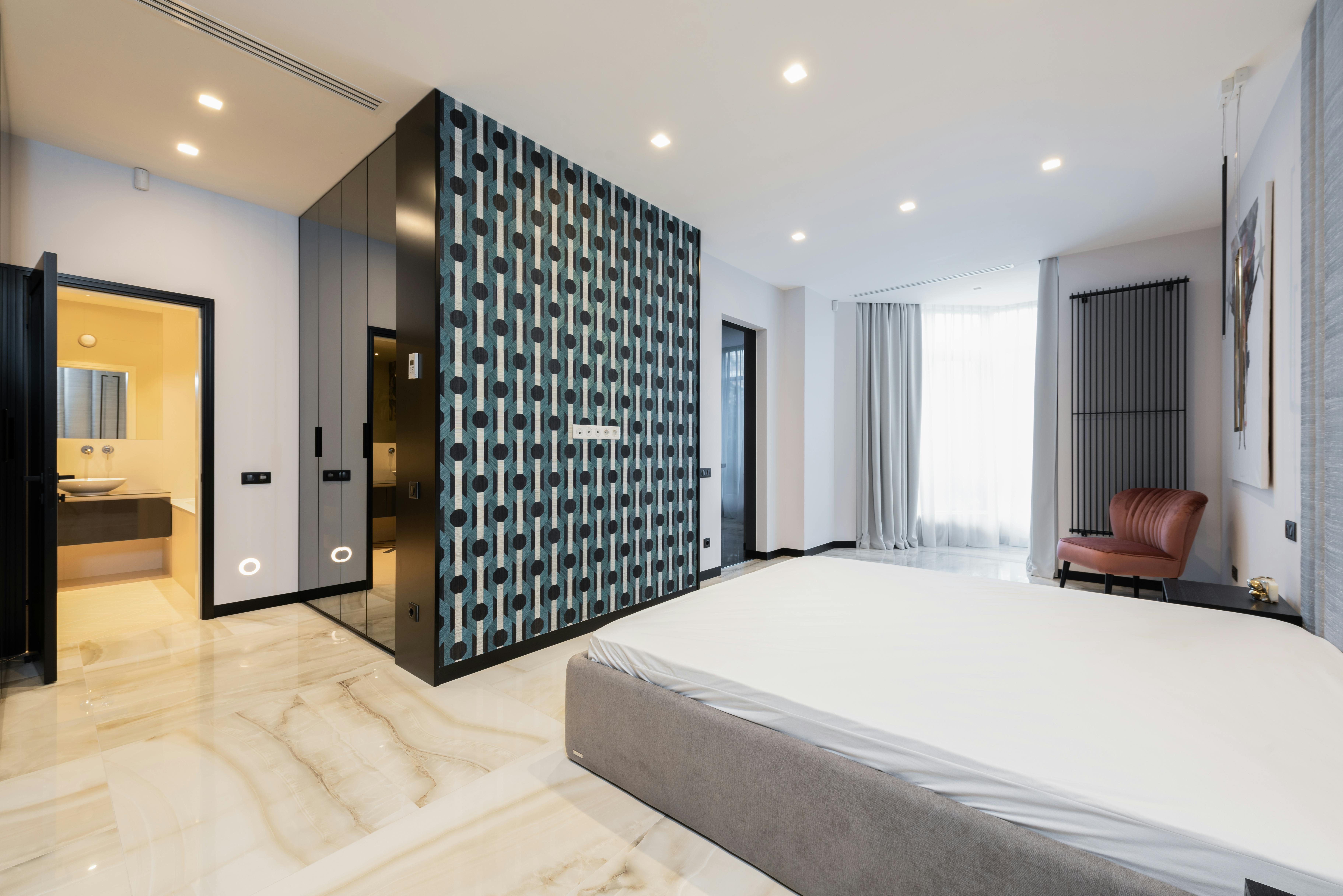 Bedroom interior with bed near table with TV · Free Stock Photo