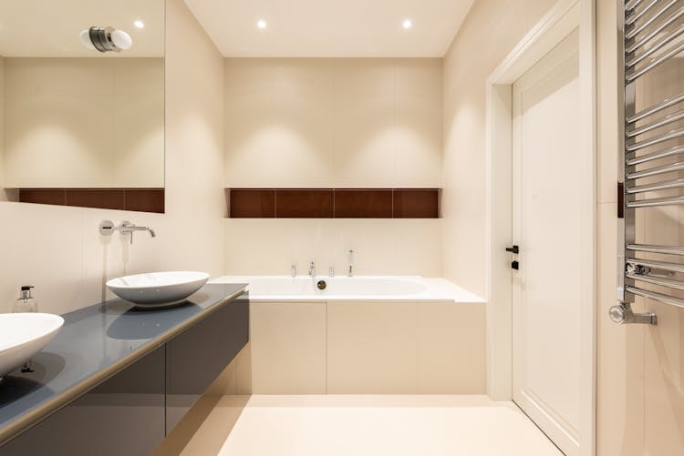 Bathroom Interior With Bath Near Sinks On Counter Near Mirror