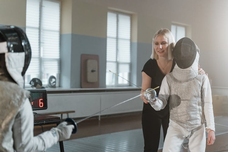 A Woman Instructor Training Fencers 