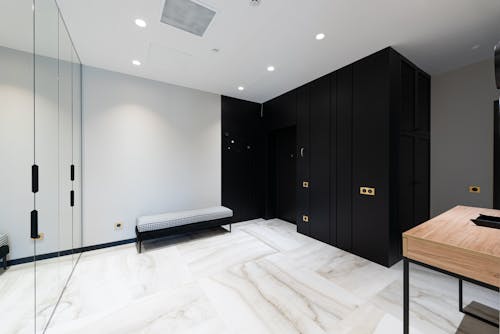 House interior with cabinet near door and bench in hallway