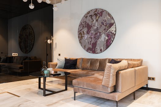 Contemporary living room featuring a plush sofa, round artwork, and elegant decor.