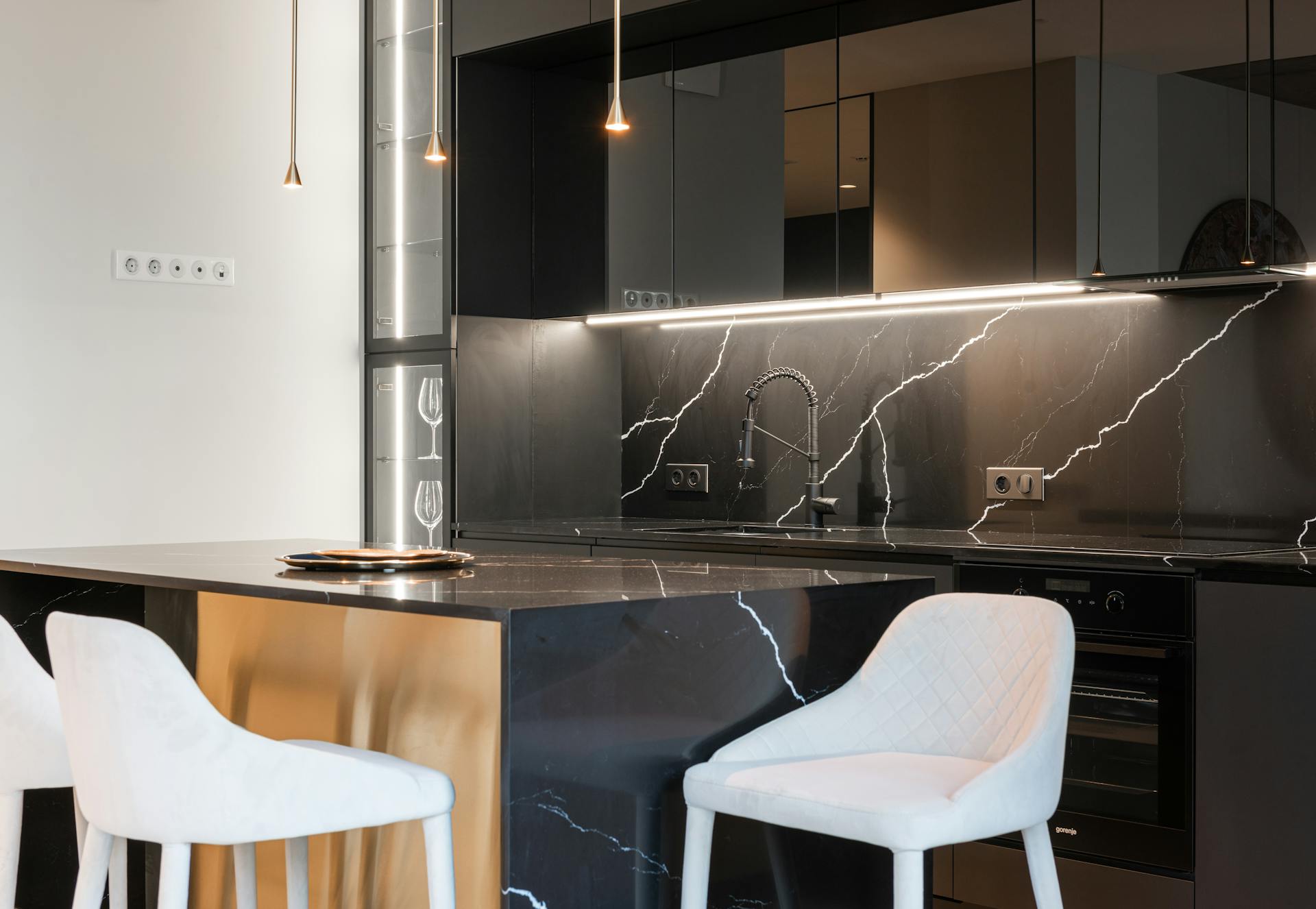 Kitchen interior with chairs near counter and cabinets