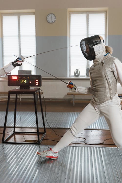 A Person Practicing Fencing Wearing Fencing Gears