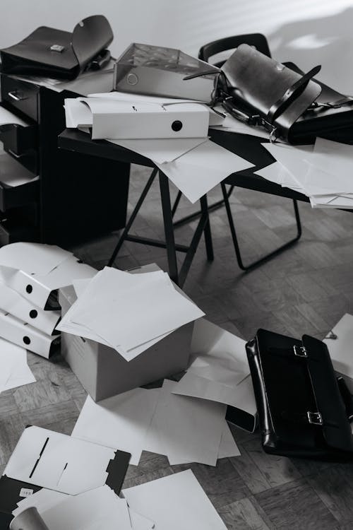 Grayscale Photography of a Messy Office 