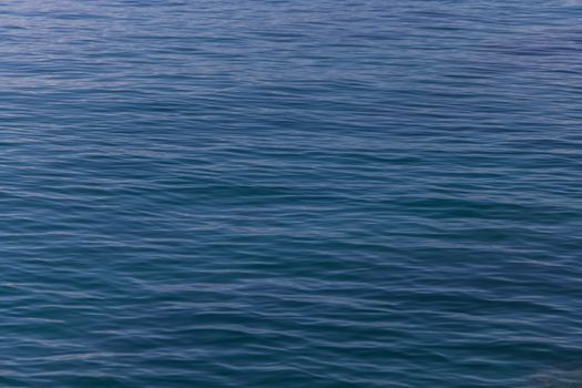 Calm ocean waves under soft twilight, creating a serene and peaceful ambiance.