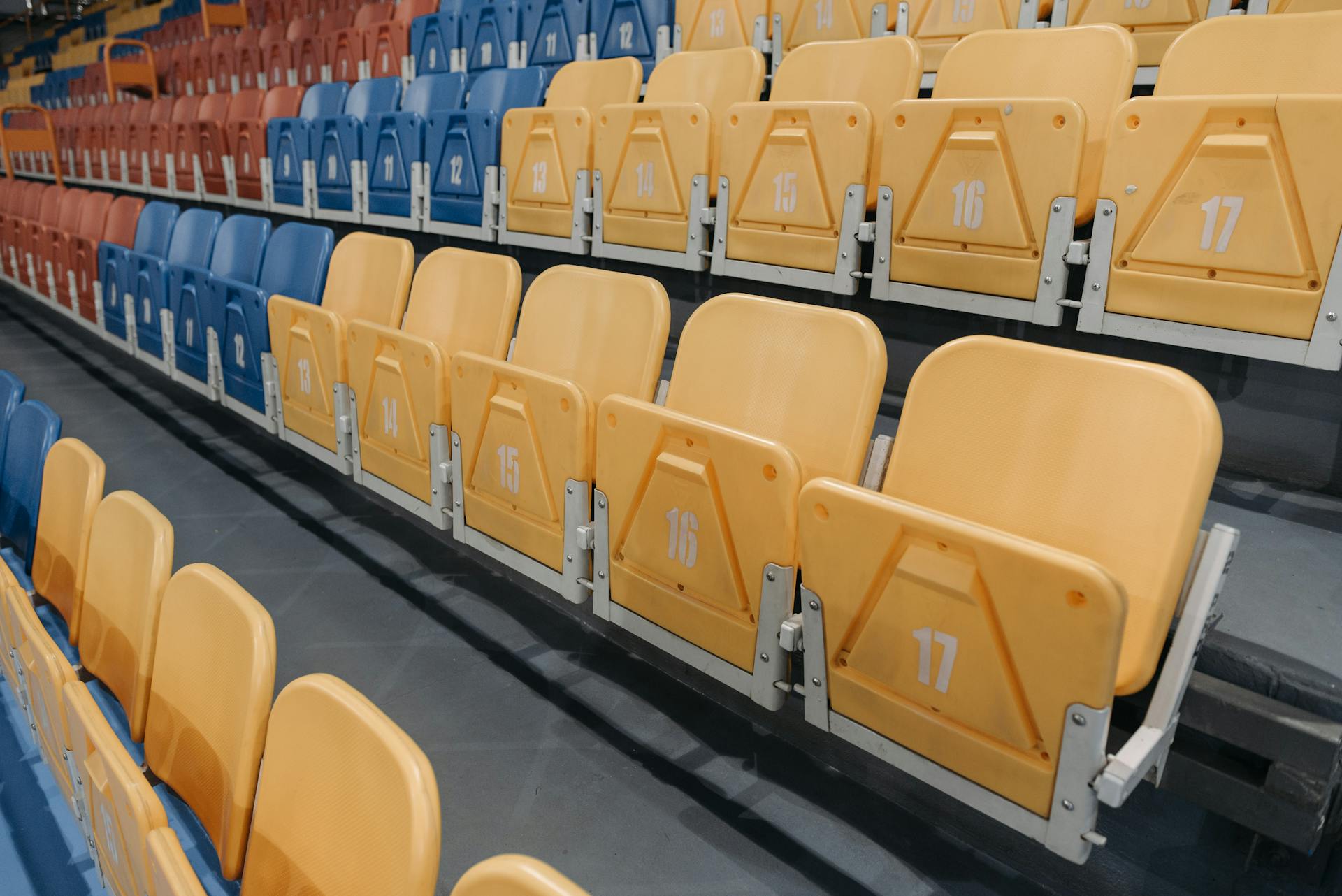 Colorful empty seats in a stadium bleachers perfect for sports events and concerts.