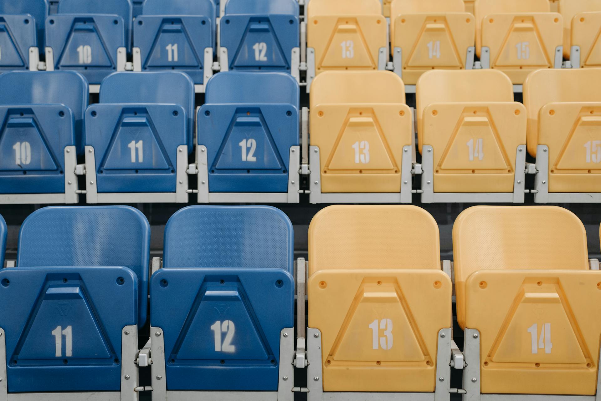 Blue and Yellow Folding Plastic Seats in the Grandstands