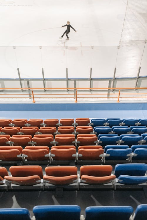 A Skater Performing on the Rink Near Empty Bleachers