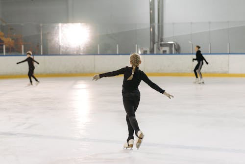A Person Ice Skating at the Ice Rink