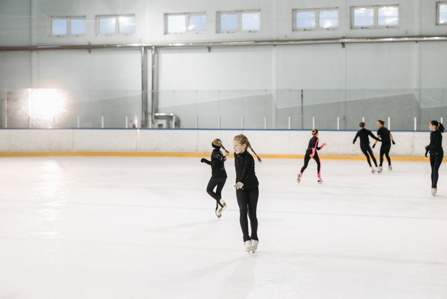 Young athletes practicing on an indoor ice rink