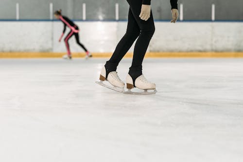 Person Wearing White Ice Skates