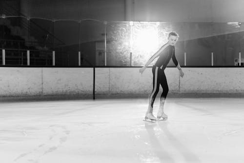 Black and White Photo of a Girl Skating